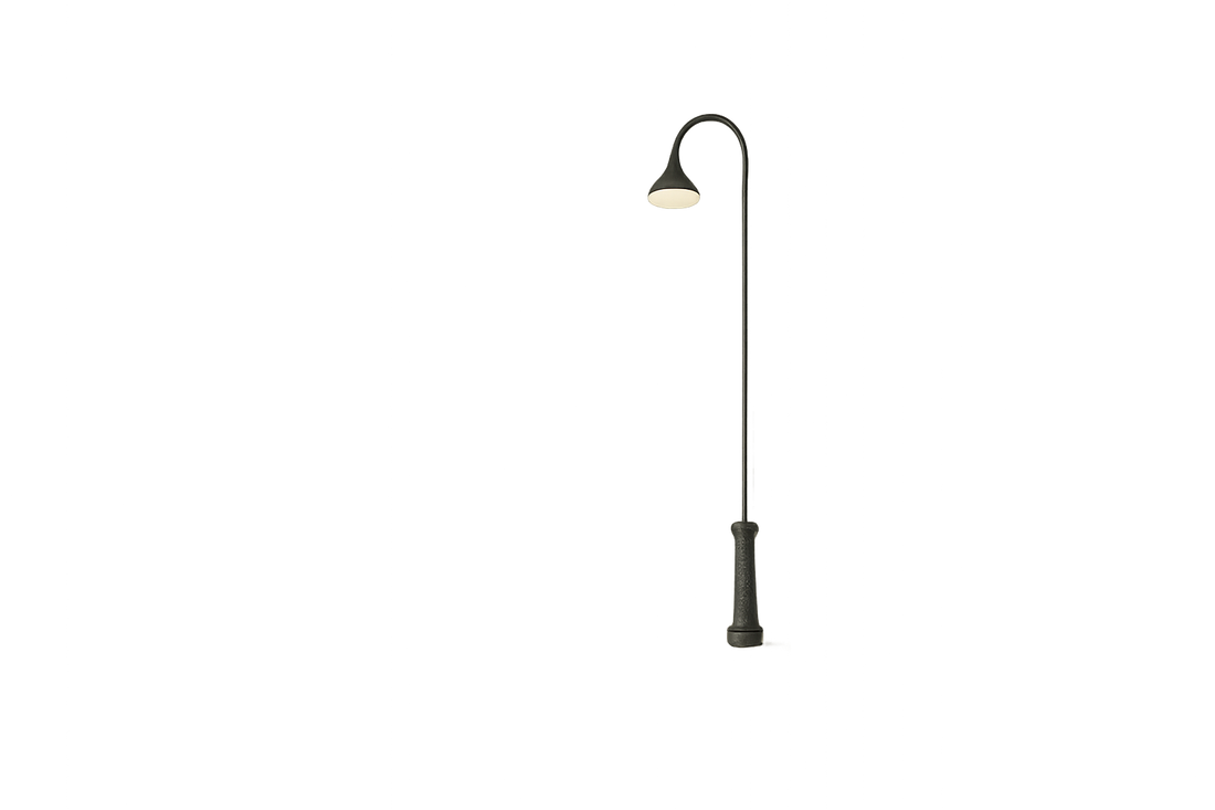 Minimalist empty street with single glowing streetlight at night.