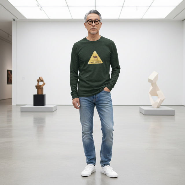 Man wearing a green long-sleeve shirt with a logo in an art gallery