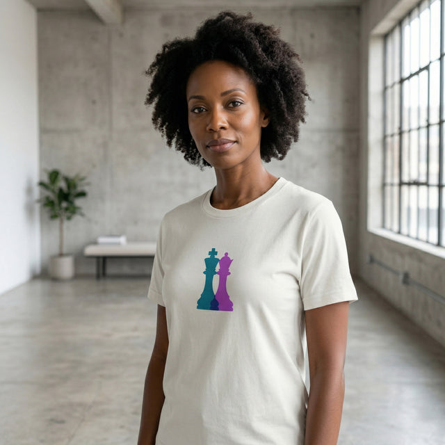 Woman wearing a white t-shirt with colorful chess piece design in an indoor setting.