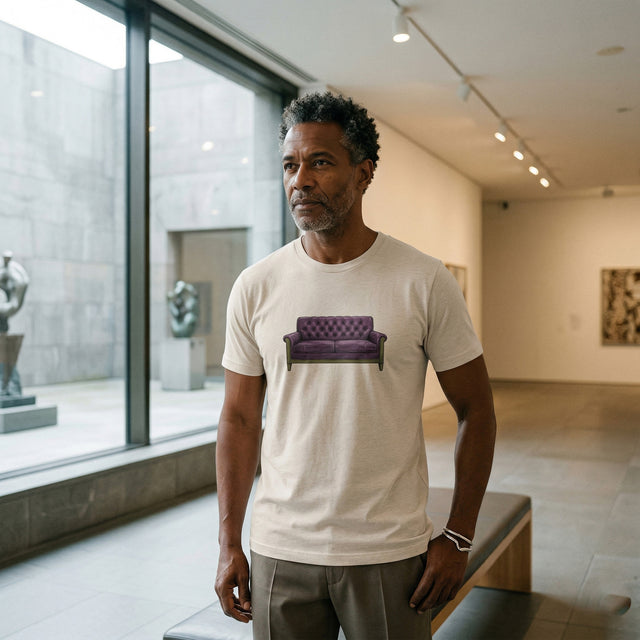 Man wearing a white t-shirt with a purple couch graphic in an art gallery.