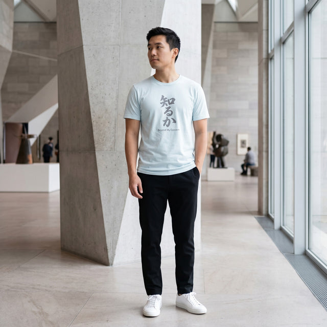 Man wearing a light blue t-shirt with text in a modern indoor setting