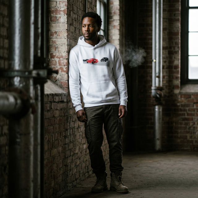 Person wearing a white hoodie with a logo in an industrial setting