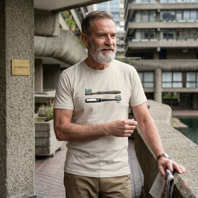 Man wearing a white t-shirt with toothbrush designs in an urban setting