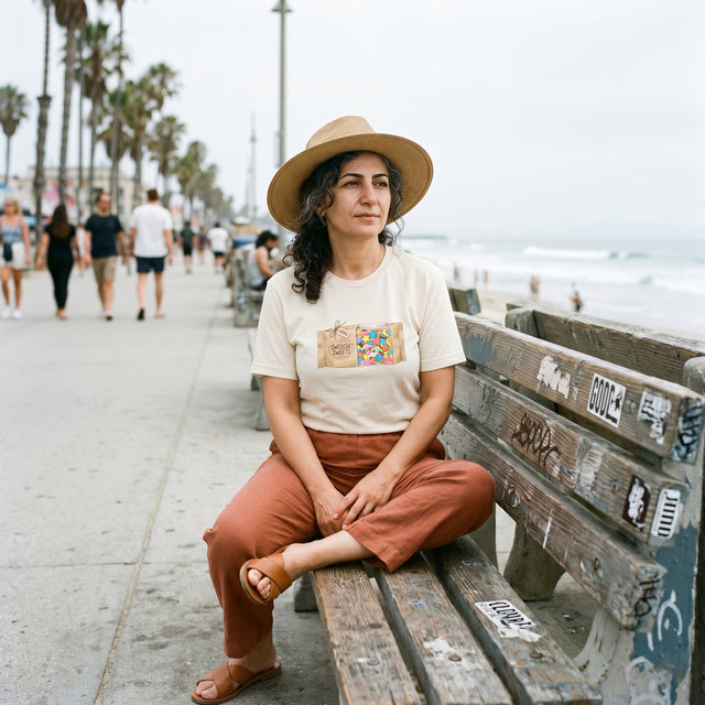 Woman sitting on a bench by the beach with palm trees in the background