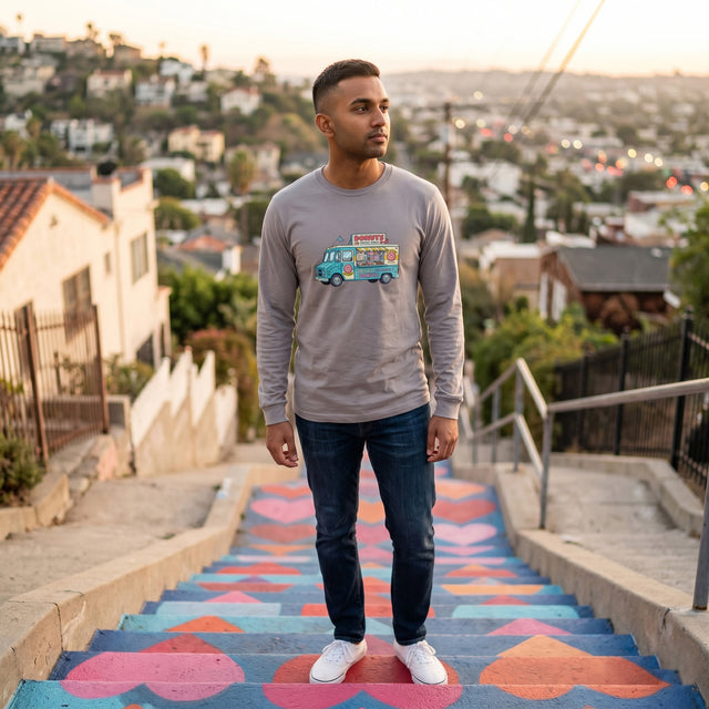 Man standing on a colorful staircase with a cityscape in the background