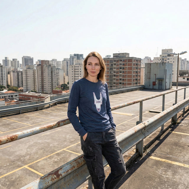 Person standing on a rooftop with cityscape in the background
