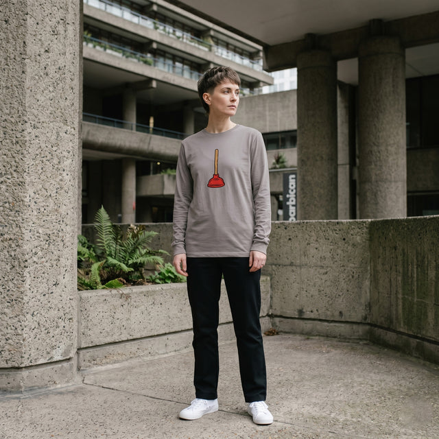 Person wearing a long-sleeve shirt with a graphic design in an urban setting