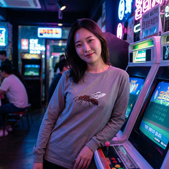 Woman standing in an arcade with colorful neon lights and gaming machines.