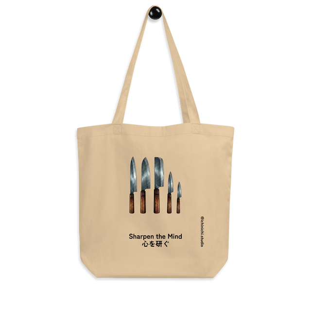 Minimalist cross-hatch illustration of five Japanese kitchen knives hanging vertically, wooden handles, Eco Tote Bag.