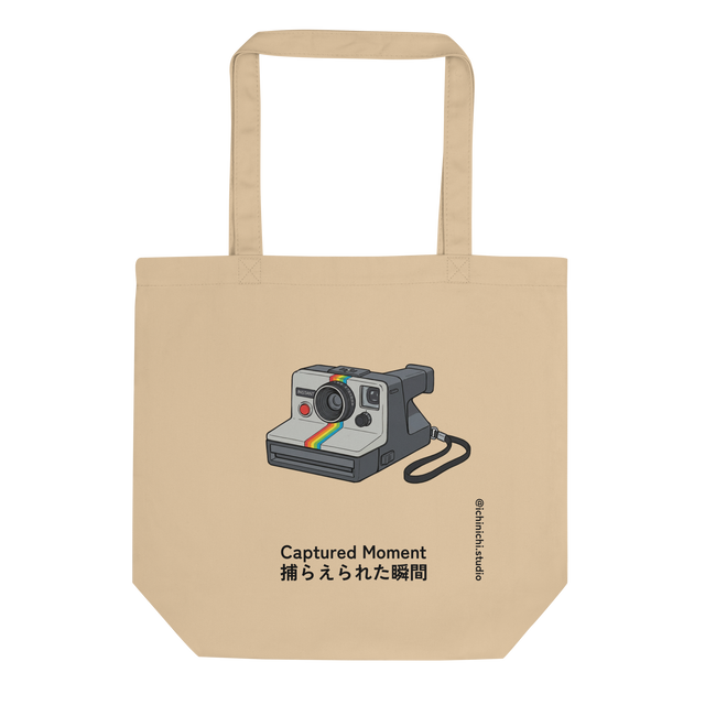 Marker illustration of a 1970s instant camera with a rainbow stripe and flash, centered on an Eco Tote Bag.