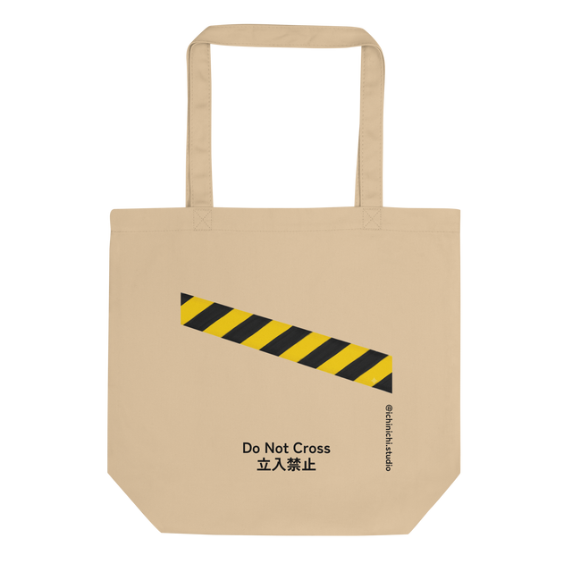 Eco Tote Bag featuring a bold painted yellow and black caution tape diagonal stripe.