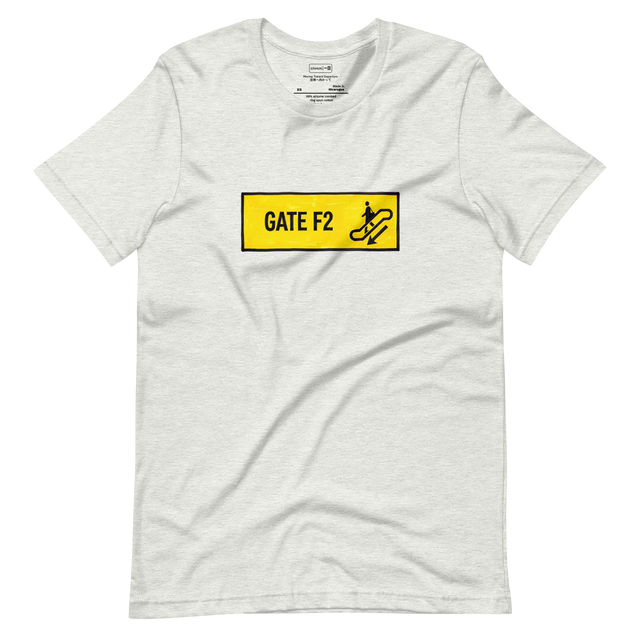 Short Sleeve T-Shirt with a yellow marker drawing of a GATE F2 transit sign, a figure carrying a bag on an escalator, and a downward arrow.