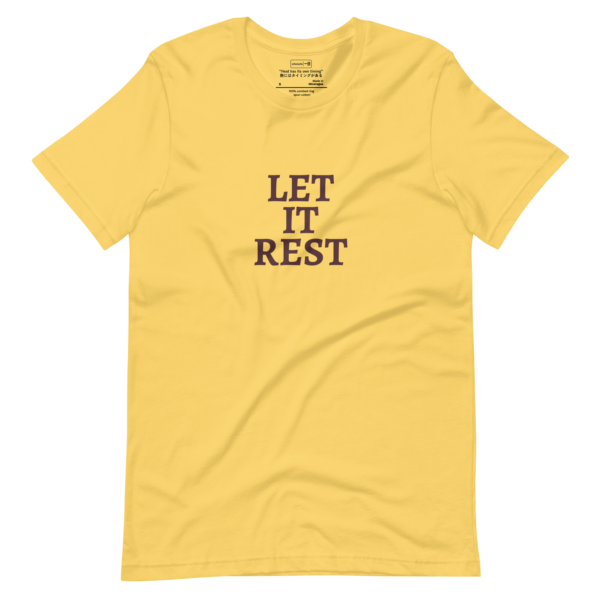 Text-based design with the words “Let It Rest” in bold serif on a yellow shirt