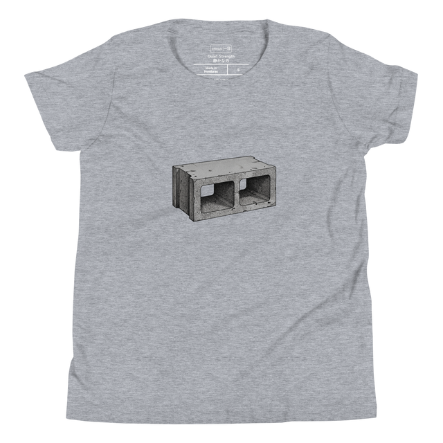 Stippled concrete cinder block graphic on youth t-shirt front.