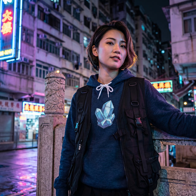 Person standing on a street at night with neon signs and buildings in the background
