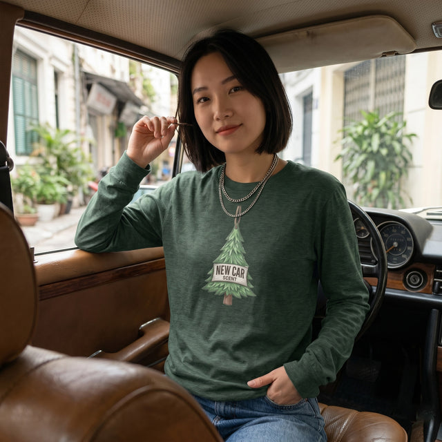 Woman wearing a green sweatshirt with a tree graphic inside a car.
