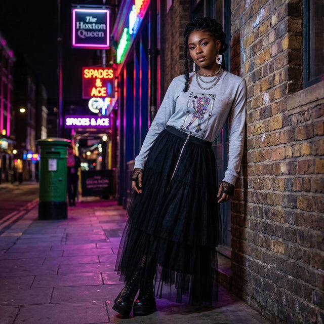 Woman leaning against a brick wall in an urban street at night with neon signs.
