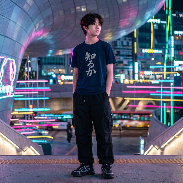 Person standing in a futuristic cityscape with neon lights