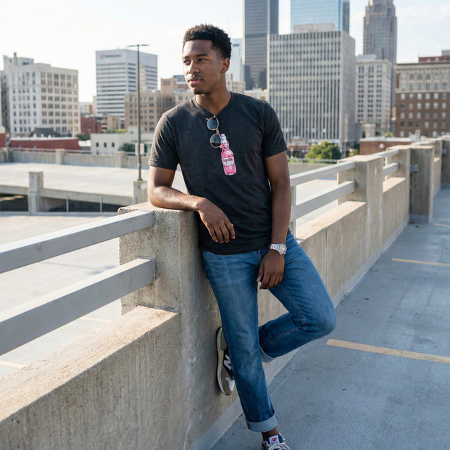 Man leaning against a railing on a rooftop with a cityscape in the background