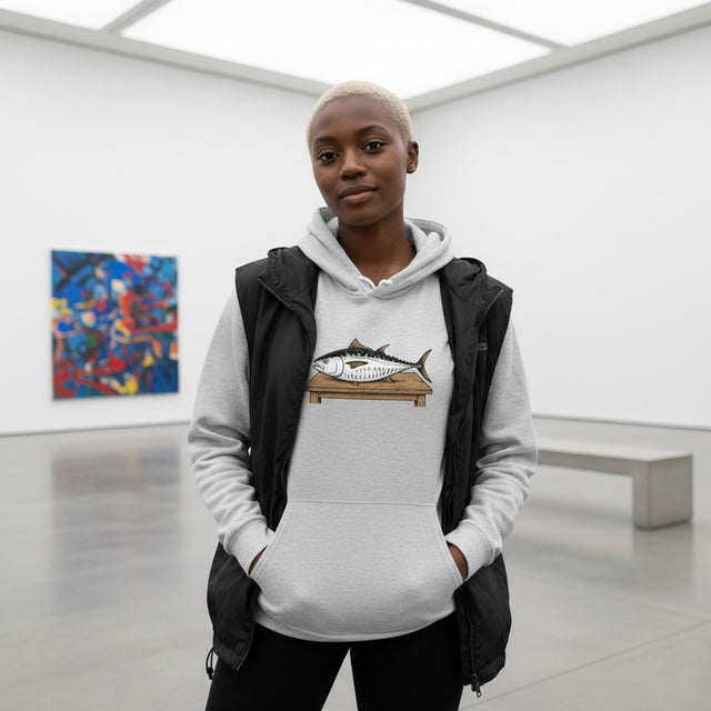 Person wearing a hoodie with a fish design in an art gallery