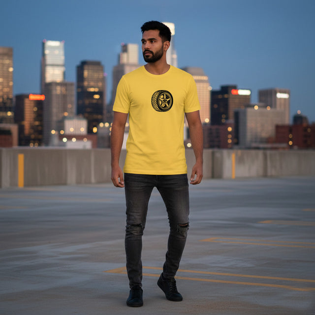 Man wearing a yellow t-shirt with a logo on a rooftop with city skyline in the background
