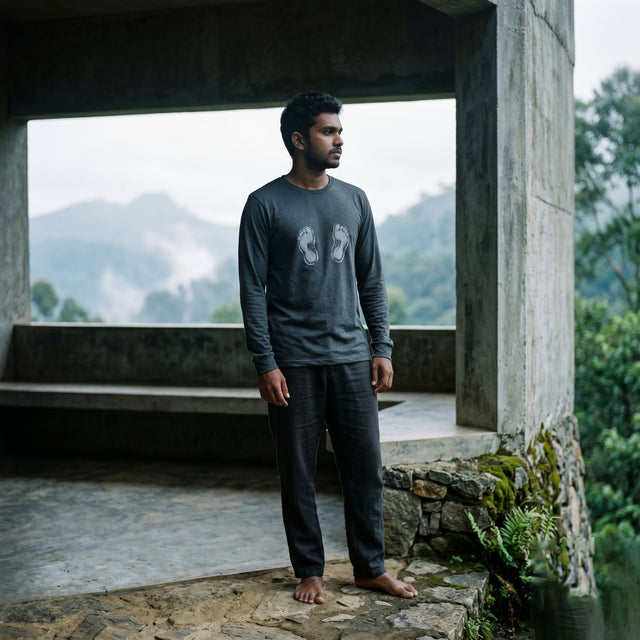 Man standing in a scenic outdoor setting with mountains in the background