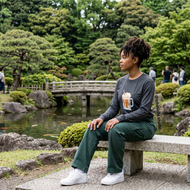 Person sitting on a bench in a park with a pond and trees in the background