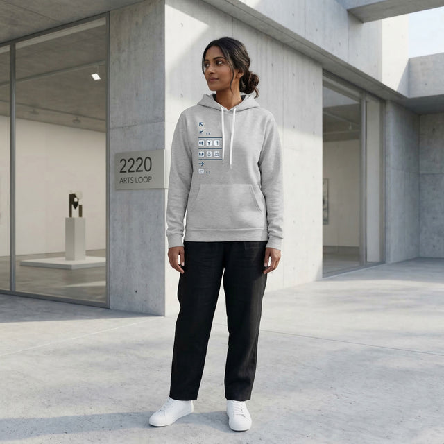 Person wearing a gray hoodie with text design in an indoor setting