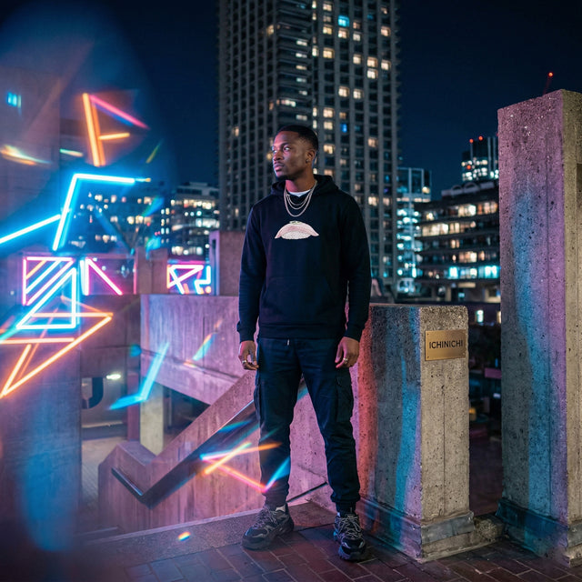 Man standing on a rooftop at night with cityscape and neon lights in the background