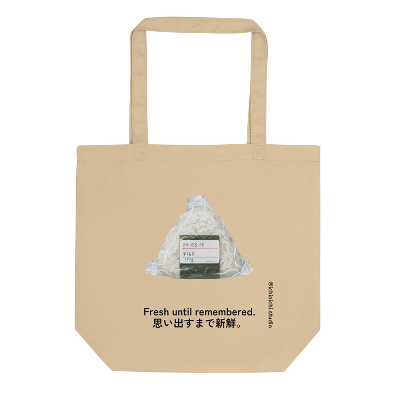 Minimalist Eco Tote Bag design featuring a wrapped onigiri with expiration date, price, and weight label.
