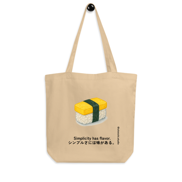 Minimalist Eco Tote Bag design featuring a single tamago sushi wrapped with dark green nori.
