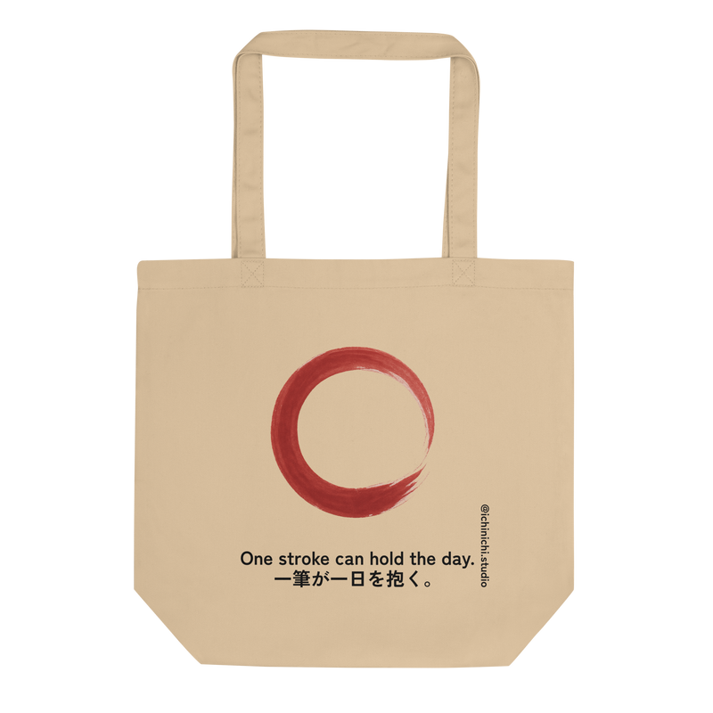 Minimal red brushstroke forming an imperfect rising circle on a tote bag design.
