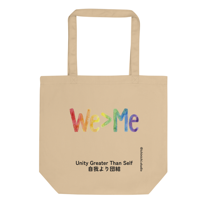 Eco Tote Bag featuring "We > Me" typography filled with a hand-drawn rainbow gradient.