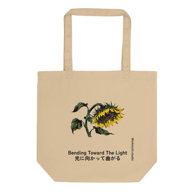 A clean digital mock-up of an Eco Tote Bag featuring a full color ink wash illustration of a single drooping sunflower on the front.