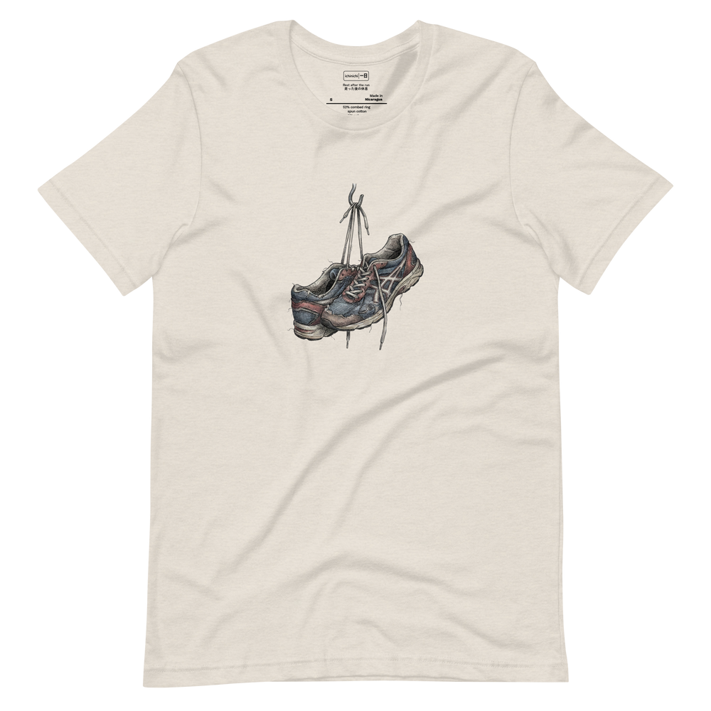 Line art illustration of worn-out running sneakers hanging by their laces on a hook on a white T-Shirt.