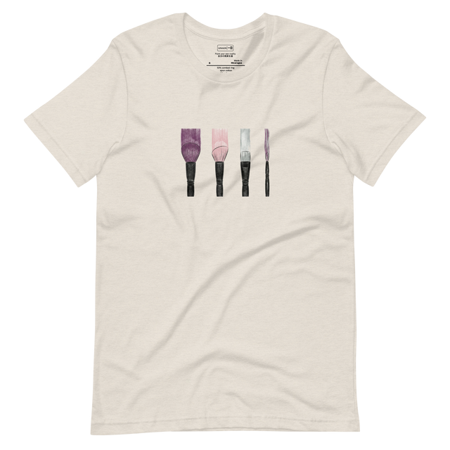 Four makeup brushes illustrating trails of purple, pink, and silver on a minimalist T-Shirt.