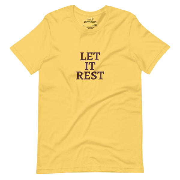 Text-based design with the words “Let It Rest” in bold serif on a yellow shirt
