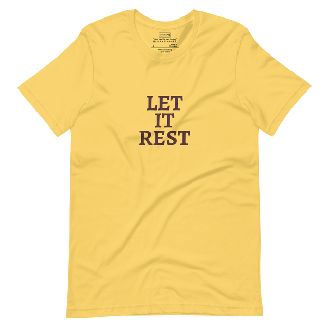 Text-based design with the words “Let It Rest” in bold serif on a yellow shirt

