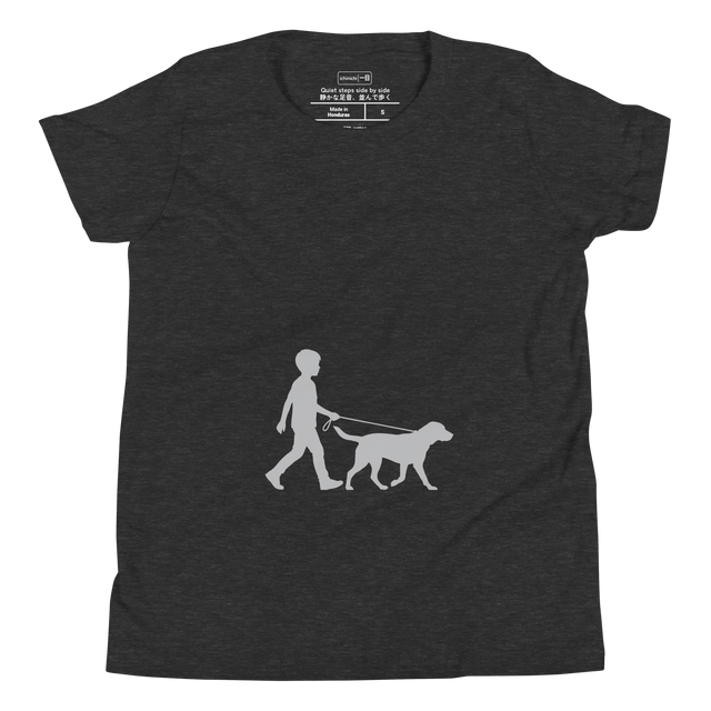 Crisp light grey silhouette illustration of a boy taking his dog for a walk, shown on a Youth T-Shirt.